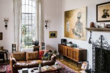 04 an electic living room with modern furniture balanced with vintage artworks and boho chic rugs