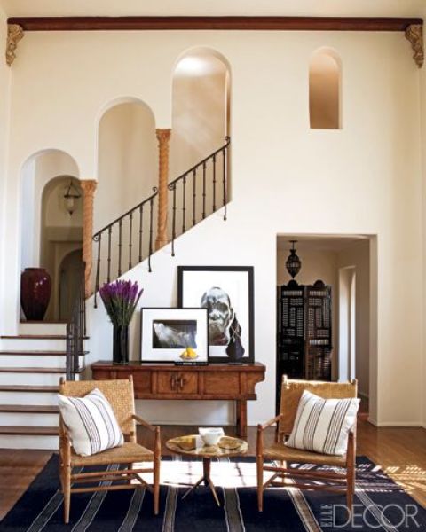 neutral textural walls, wrought railings, little pillars and wooden furniture make up a cool MEditerranean space neutral textural walls, wrought railings, little pillars and wooden furniture make up a cool MEditerranean space
