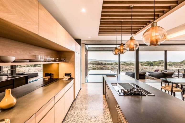 The kitchen, dining and living rooms are united into a single and comfortable volume with lights and modern furniture The kitchen, dining and living rooms are united into a single and comfortable volume with lights and modern furniture