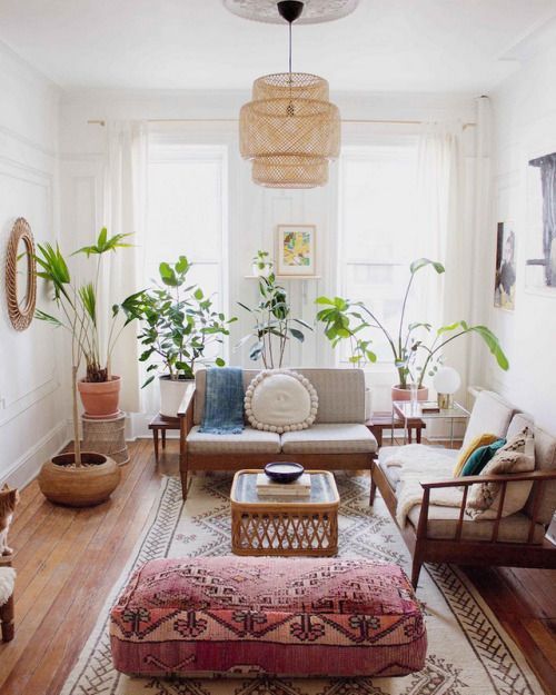 an eclectic living room done with mid-century modern furniture and balanced with boho chic textiles and wicker rustic lamps