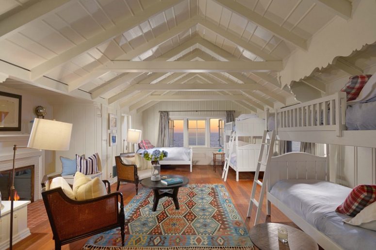cozy guest bedroom design Here's a guest bedroom with gorgeous views of the sea and a fireplace for coziness