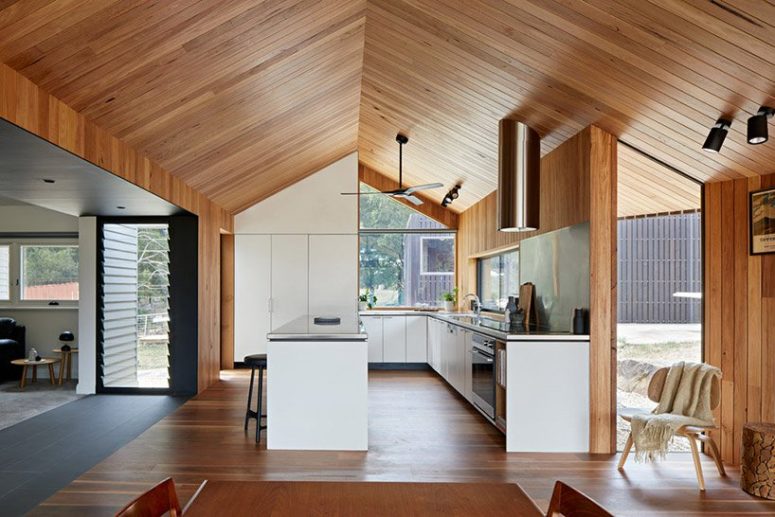 The kitchen is done with white cabinets and stainless steel appliances for a laconic and modern look