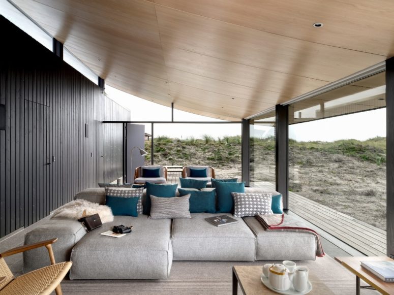 The living room is a vast space with glazed walls to stay here and enjoy the views while talking to friends