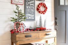 06 a gorgeous gallery wall for holidays with a couple of wreaths, signs and a fake deer head for your entryway