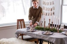 06 natural evergreen garlands and a matching table runner plus wooden candle holders are great for a hygge space