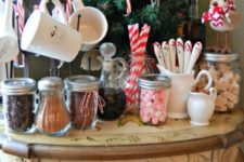 07 a vintage table as a hot chocolate station with sweets and a little Christmas treee in the corner