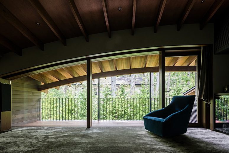 The upper floor features a comfy reading nook with views and a cozy chair