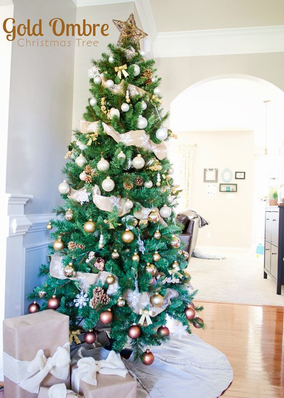 a chic metallic Christmas tree with an ombre effect from silver to gold and chocolate, a twig star on top and white snowflakes
