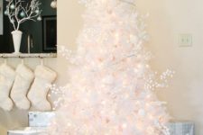 09 a pure white Christmas tree decorated with lights, branches, ornaments and lights seems very airy and beautiful