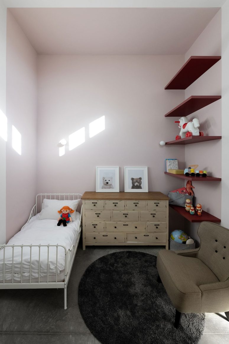 The kid's room is done with light pink, neutrals and open shelving