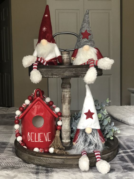 a fun Christmas display with gnomes, a house and bead garlands all done in red and white