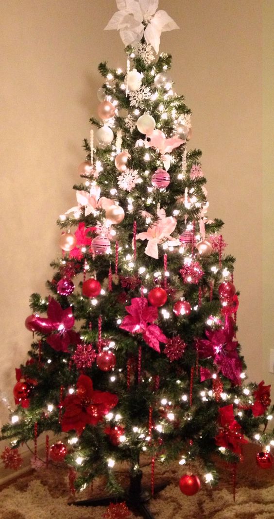 a fun and bold Christmas tree with ornments from pearl and silver to pink, hot pink and red plus lights and icicles