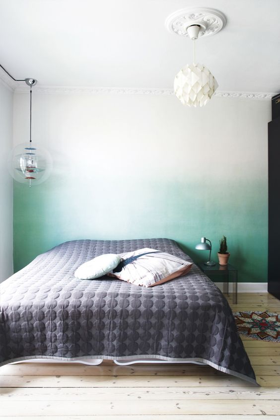 an ombre green statement wall behind the headboard is a peaceful yet catchy touch of color to the bedroom