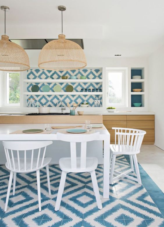 blue and white mosaic tiles clad the backsplash and the floor bring strong Mediterranean vibes to the kitchen blue and white mosaic tiles clad the backsplash and the floor bring strong Mediterranean vibes to the kitchen