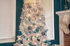 12 a white Christmas tree with an ombre effect from white and silver to light blue and turquoise plus lights and snowflakes