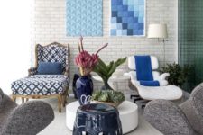 12 a white ottoman, lounger, table and lamp all staple the living room decor,and blues add color