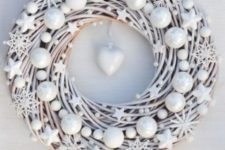 13 a beautiful white Christmas wreath decorated with stars, snowflakes and beads with a heart in the center