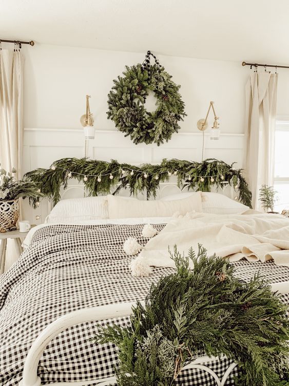 a cozy bedroom with natural decor - evergreen wreaths and garlands plus neutral and plaid textiles