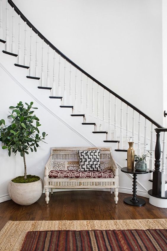 a gorgeous whitewashed wooden bench with orange legs and a back and jute rugs bring Mediterranean feel to the space a gorgeous whitewashed wooden bench with orange legs and a back and jute rugs bring Mediterranean feel to the space