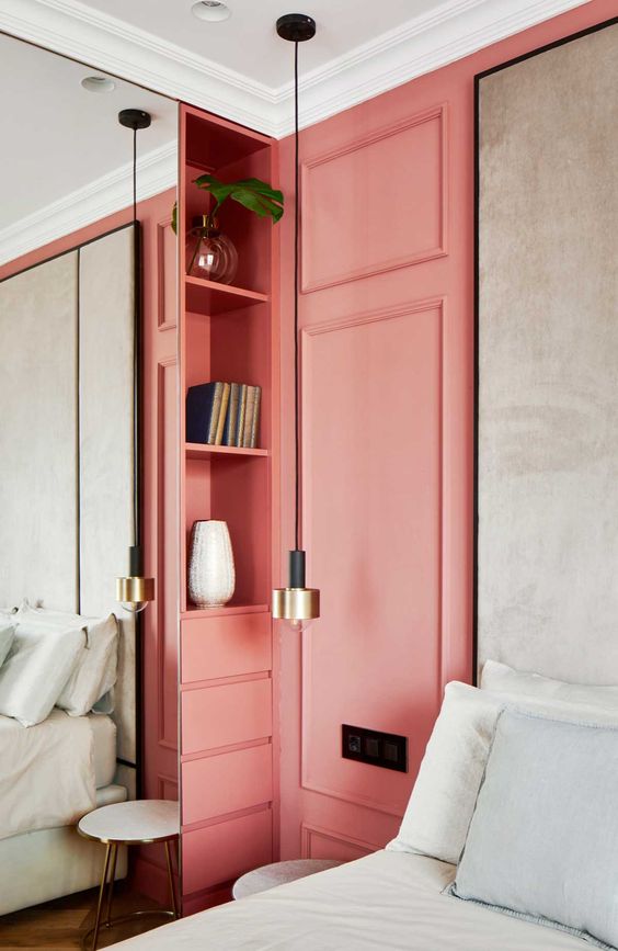 a coral panel and storage unit make a statement in this neutral bedroom