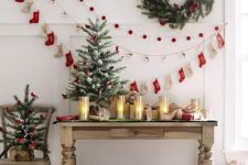 14 a pompom, paper house and decorative stocking garland plus a wreath on the wall can be a nice idea for a vintage space