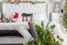 14 a welcoming modern Christmas bedroom with an evergreen wreath, garland, a basket with evergreens, lights and ornaments