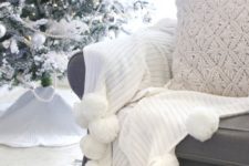 15 a beautiful white throw with pompoms and a knit pillow is a cool idea for a cozy Christmas nook