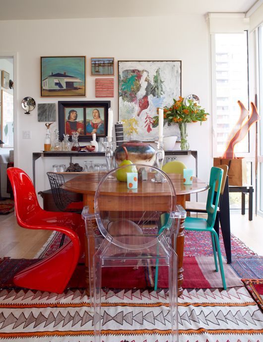a neutral space dotted with bright colors using furniture and artworks plus rugs
