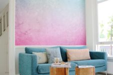 a statement gradient wall in blue and pink plus a matching sofa is a cool idea to impress with bold tones