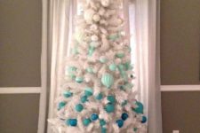 15 a white Christmas tree with ornaments to achieve an ombre effect from silver to turquoise and navy looks freezing