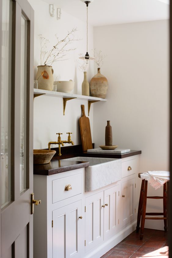 such traditional to vintage cabinets and brass fixtures immediately create a Mediterrranean feel in this Tuscan kitchen such traditional to vintage cabinets and brass fixtures immediately create a Mediterrranean feel in this Tuscan kitchen