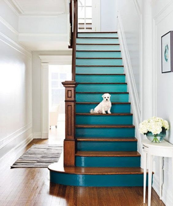 an ombre staircase from light blue to teal is a fantastic idea to spruce up usual stairs