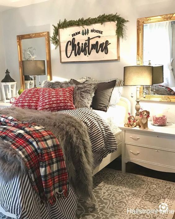 a cozy sleeping space with printed bedding, faux fur, a large sign with an evergreen garland
