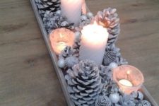 18 a snowy Christmas centerpiece of whitewashed pinecones, beads, pearls and candles is a simple DIY idea