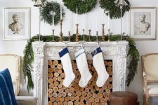 18 an arrangement of lush greenery wreaths and a matching garland on the mantel will brign a natural feel to the space