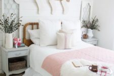 19 a cozy vintage farmhouse bedroom with faux fur, white stockings, dried herb arrangements and a striped blanket
