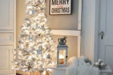 19 a neutral space is accented with a white Christmas tree with lights, ornaments and faux fur for a charming feel