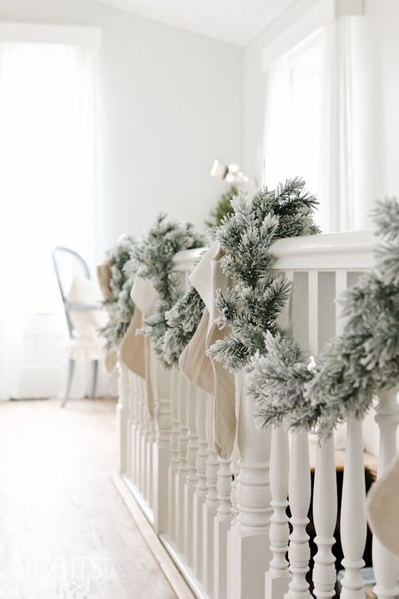a snowy evergreen garland with bows is a great decoration for any space, it's veyr easy to DIY