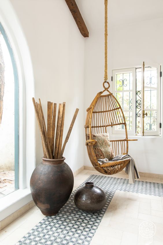 simple room design with a wicker chair a suspended wicker chair hanging inside will make it feel outside and some dark ceramics and mosaic tiles help creating an ambience