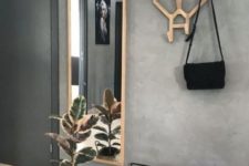 20 a creative wooden antler coat rack and a mirror in a wooden frame make an accent in a minimalist entryway