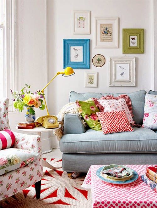a floral print chair and matching pillows instantly match the mismatching furniture (mismatched colorful photo frames also looks great)