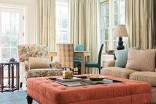 20 a large coral upholstered ottoman makes a colorful statement in this neutral living room
