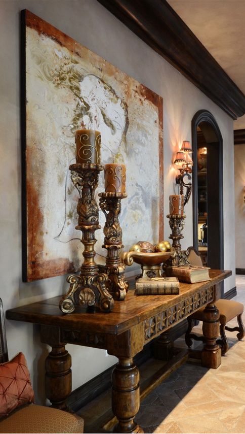 a vintage wooden table and exquisite large candle holders give this space an exquisite Mediterranean feel a vintage wooden table and exquisite large candle holders give this space an exquisite Mediterranean feel