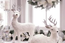 20 fake white deer, a beautiful fake evergreen wreath with silver and white ornaments and candles