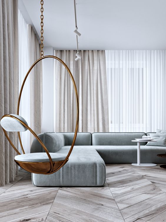 a bold suspended chair in brass and grey is a chic statement idea for a modern living room