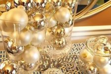 21 a display with pearly and gold Christmas ornaments is a chic and simple entryway display idea