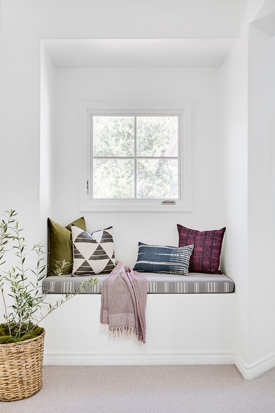 a white space with colorful textiles with prints that make this windowsill bench brighter and catchier a white space with colorful textiles with prints that make this windowsill bench brighter and catchier