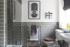 21 an elegant bathroom clad with grey subway tiles and with wooden floors is a super chic idea