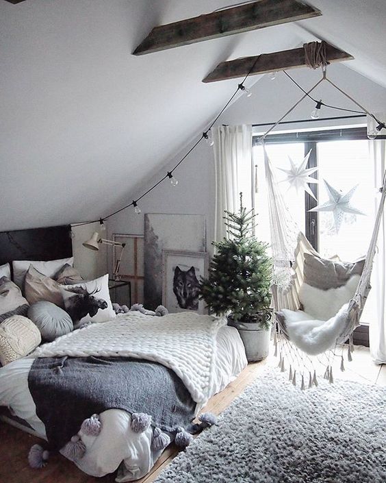 knit blankets with large tassels and a cozy faux fur rug make your bedroom welcoming and inviting