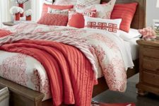 23 a bright bedding set with coral and white and lots of different prints and matching pillows and a rug cheer up a neutral space